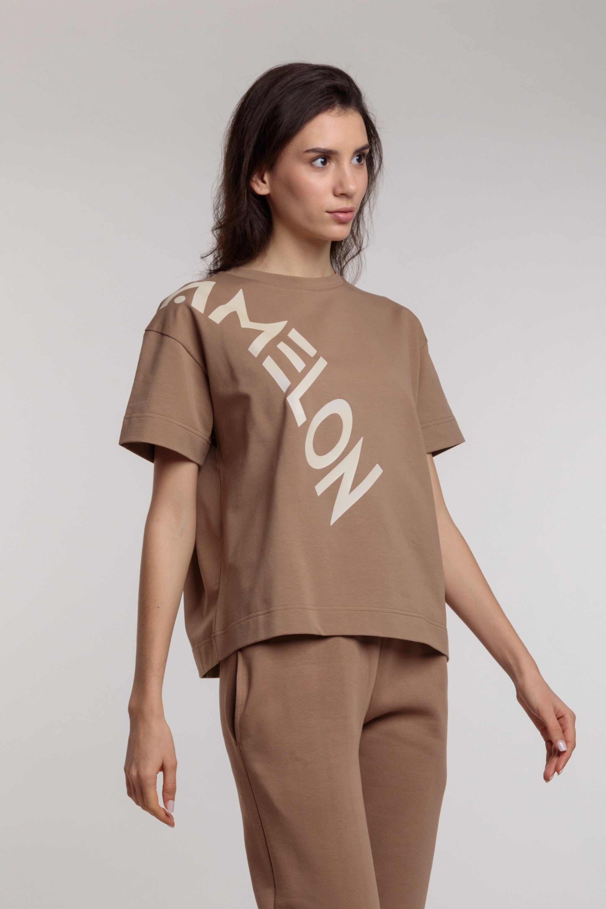 Women's straight beige t-shirt with a large milky lettering
