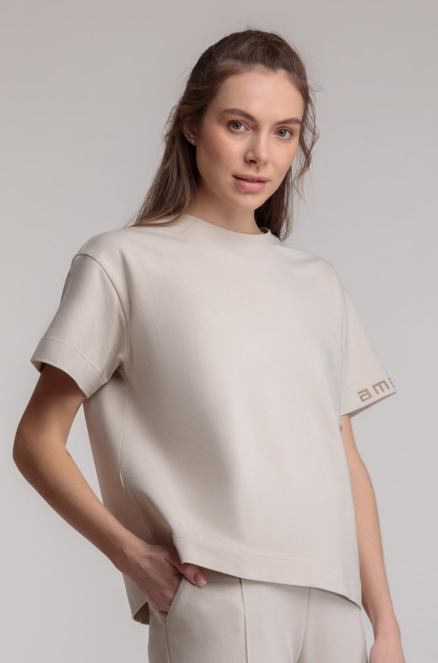 Straight women's T-shirt in milky color, logo on the sleeve