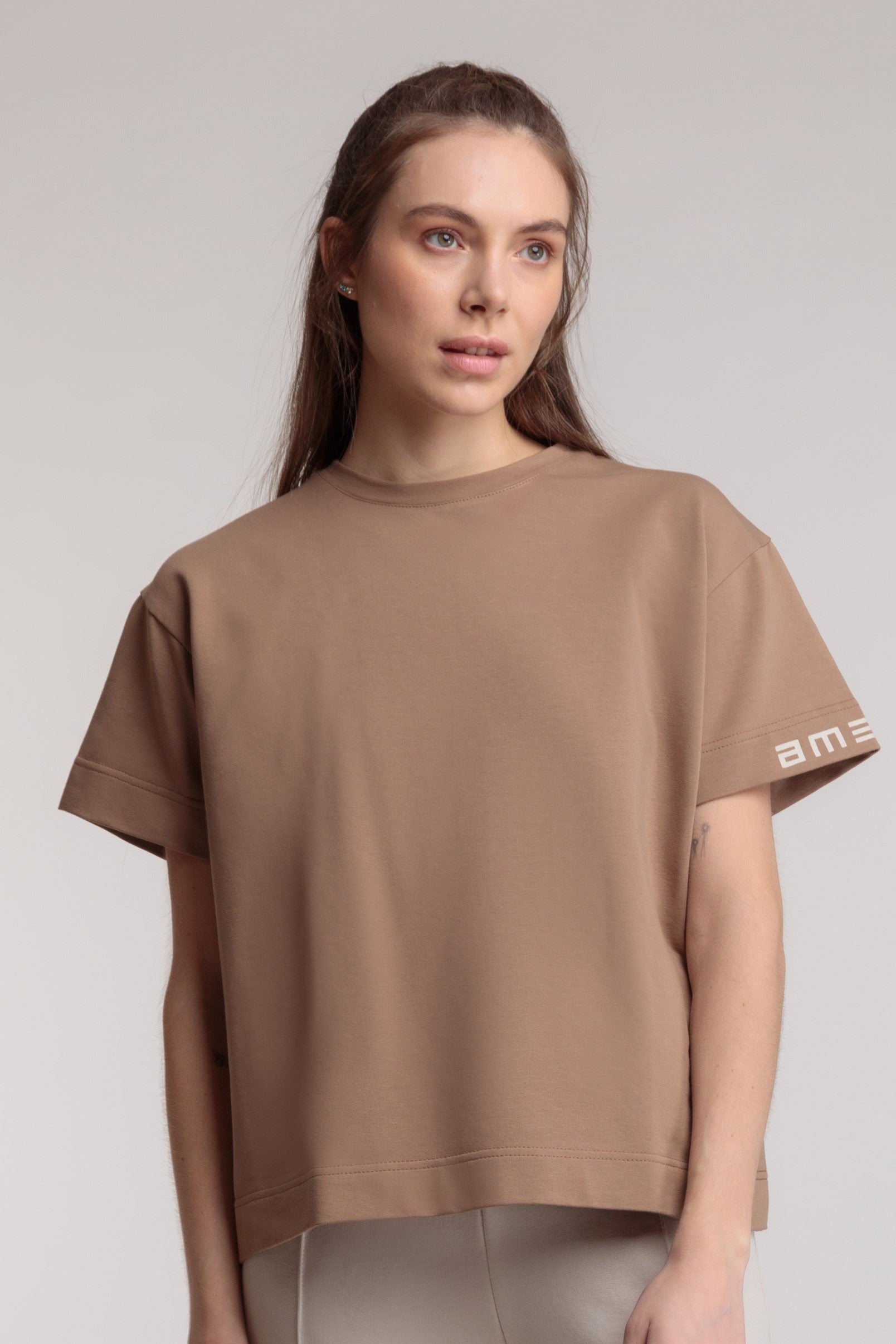 Straight women's T-shirt in beige color, logo on the sleeve