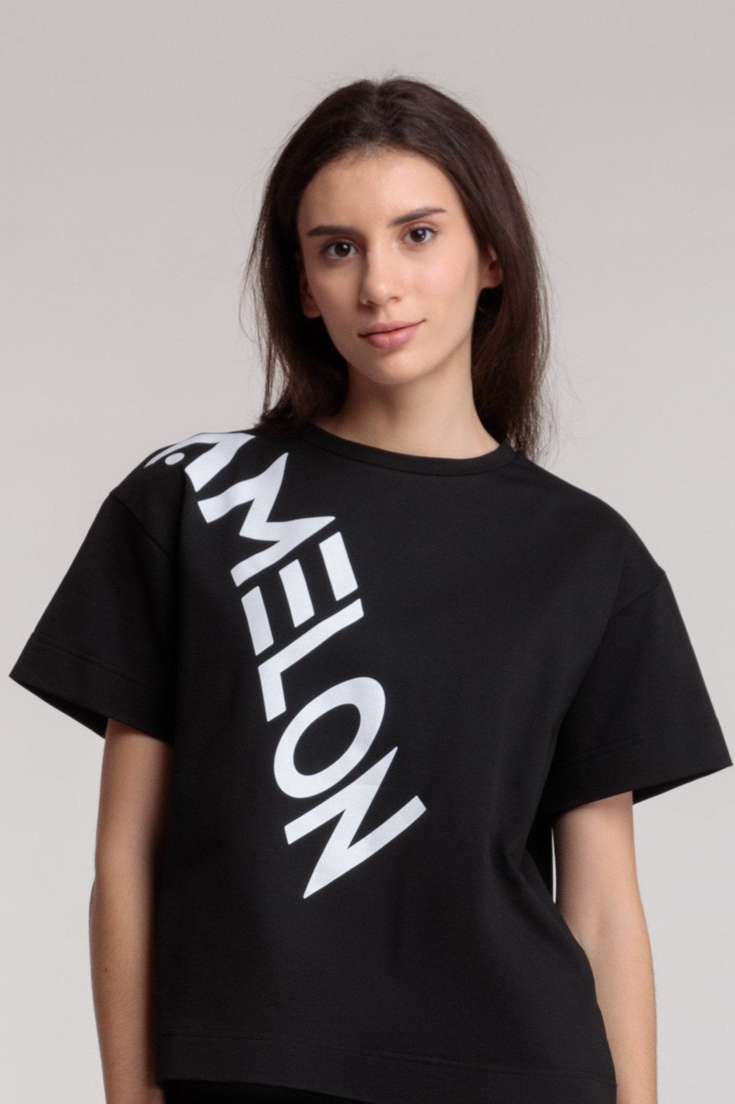 Women's straight black t-shirt with a large white lettering