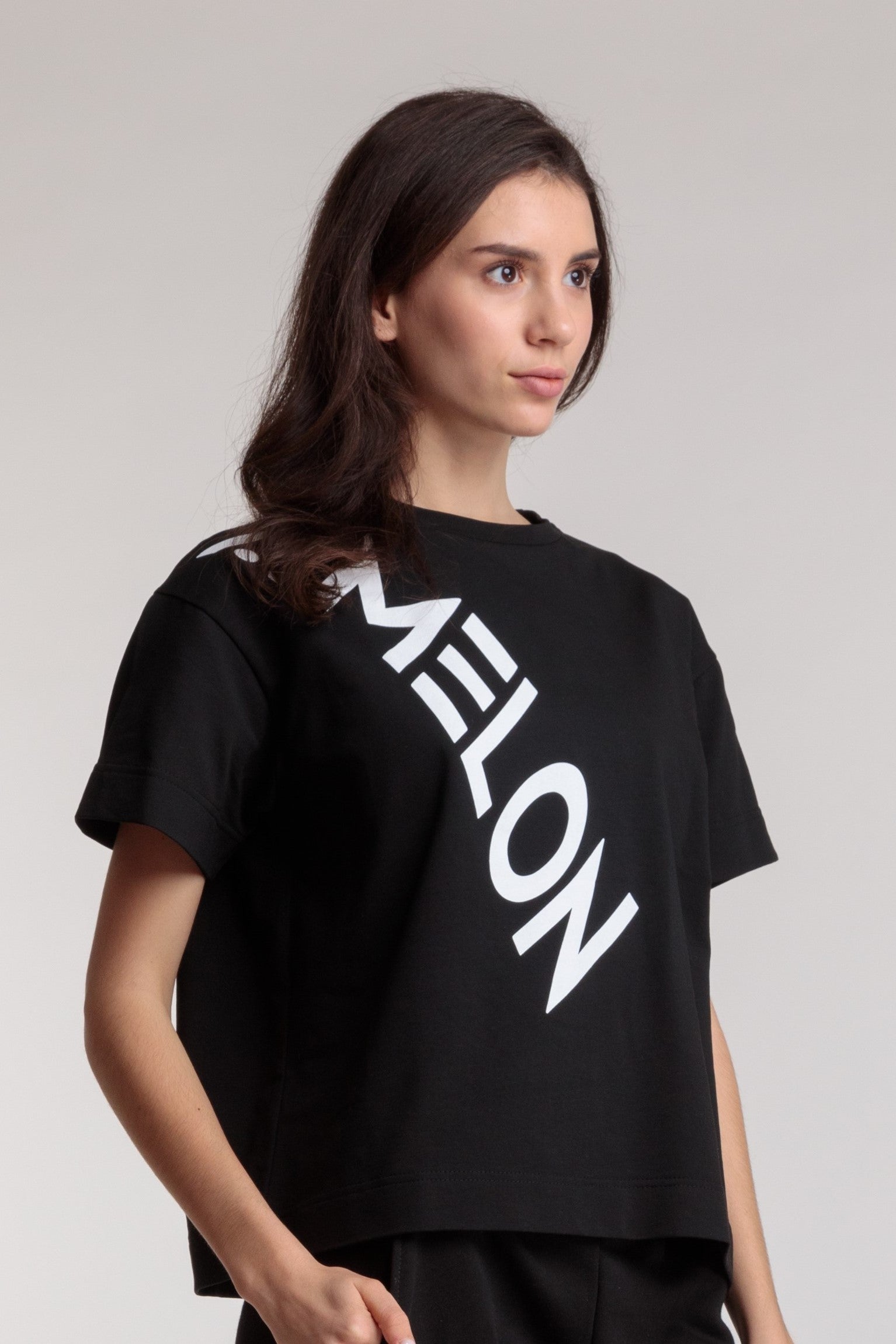 Women's straight black t-shirt with a large white lettering