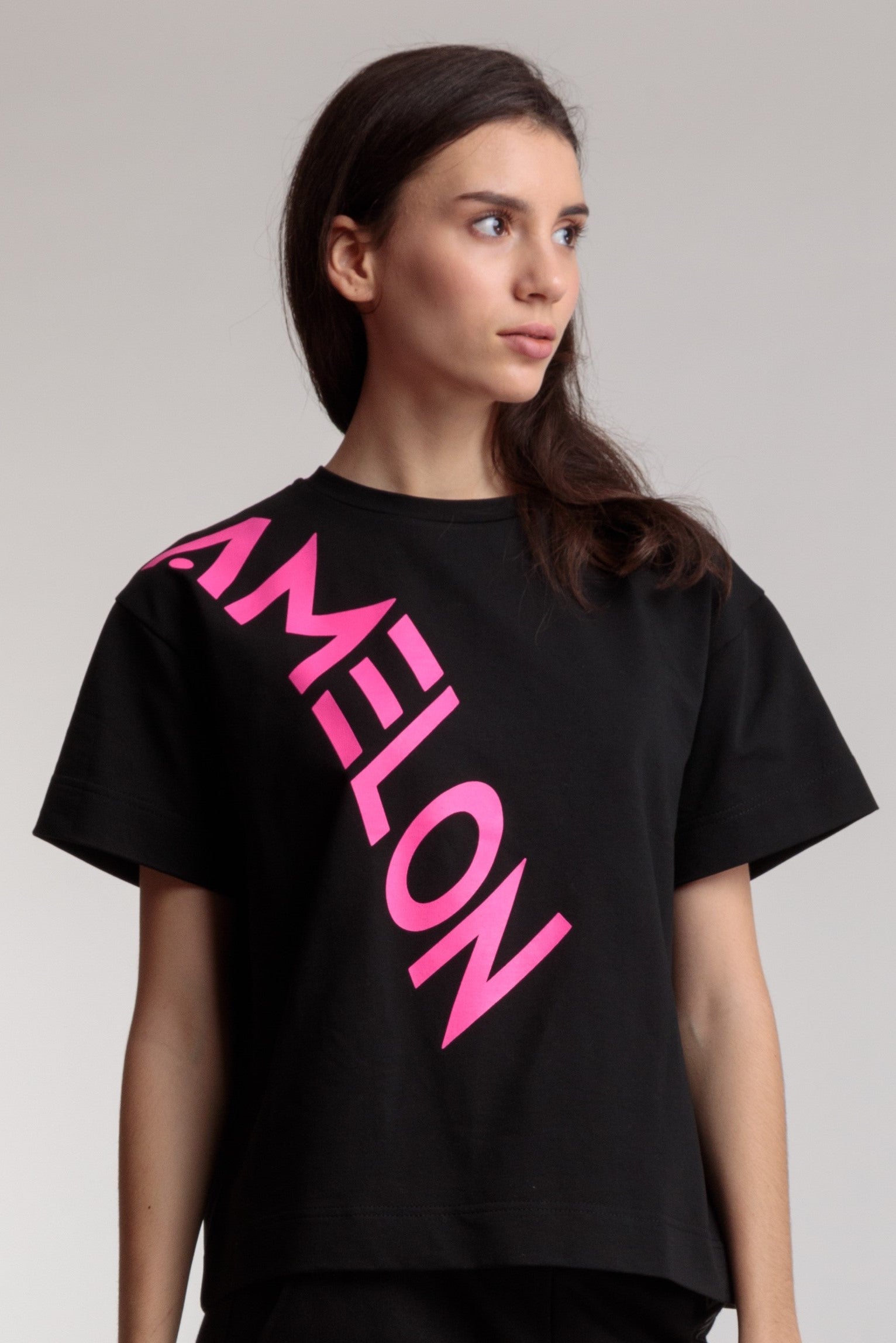 Women's straight black t-shirt with a large pink lettering