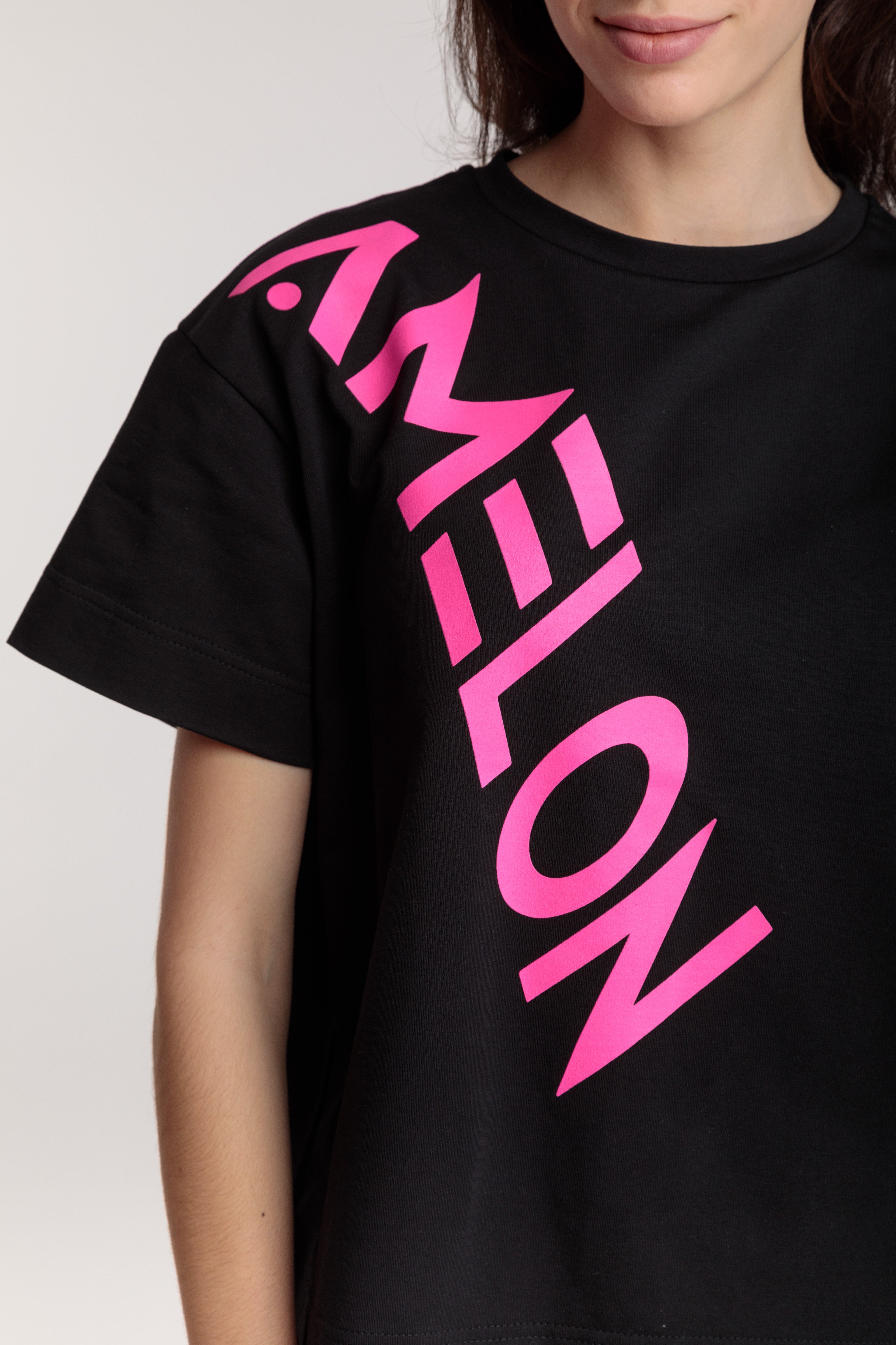 Women's straight black t-shirt with a large pink lettering