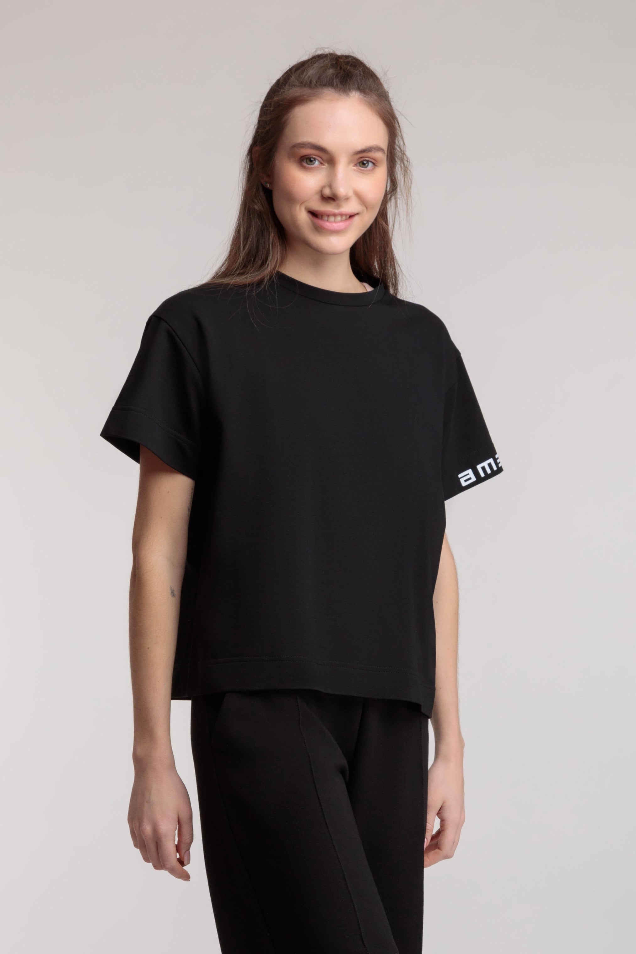 Straight women's T-shirt in black color, logo on the sleeve