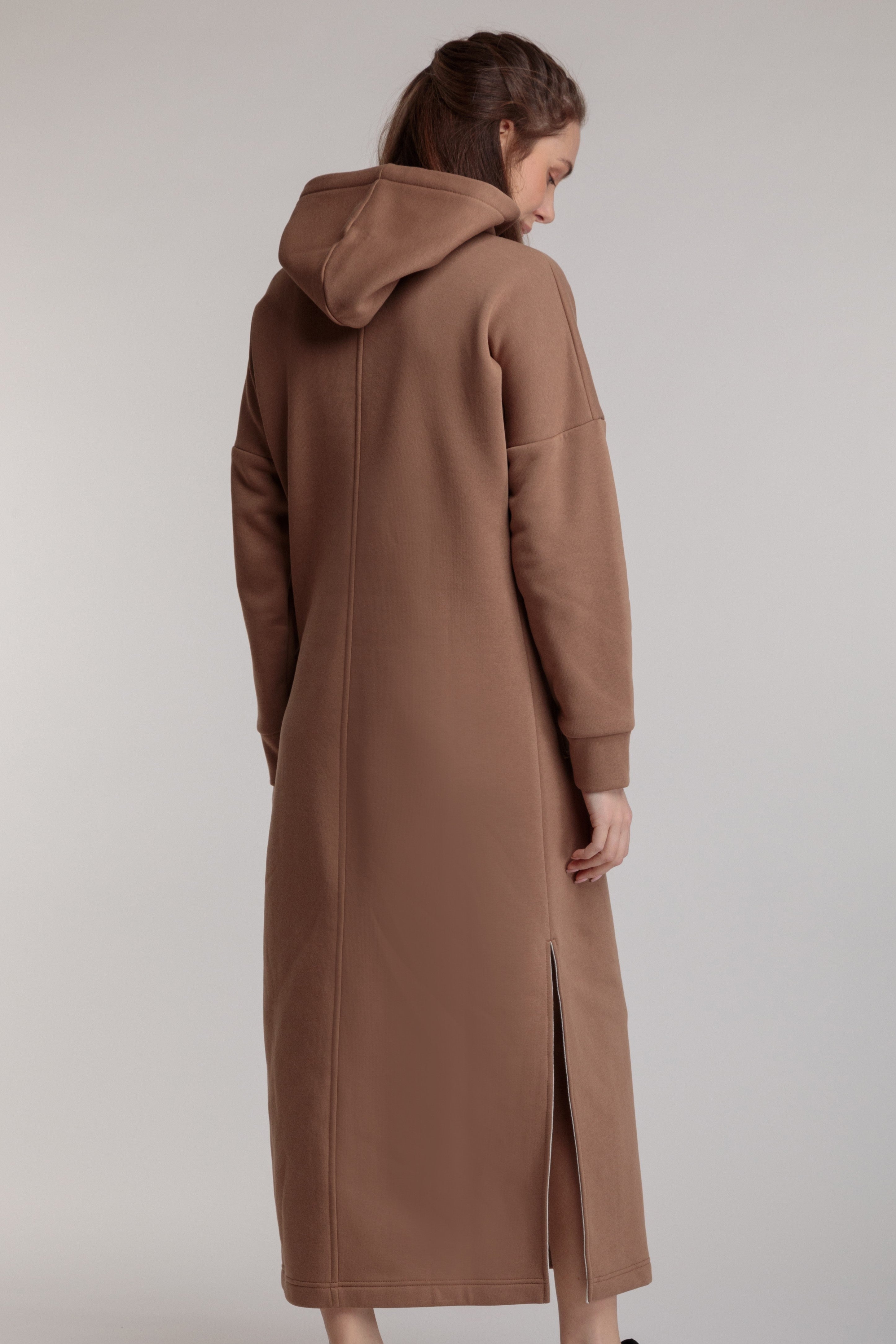 Long straight warm dress in beige color with slits, hood and pocket