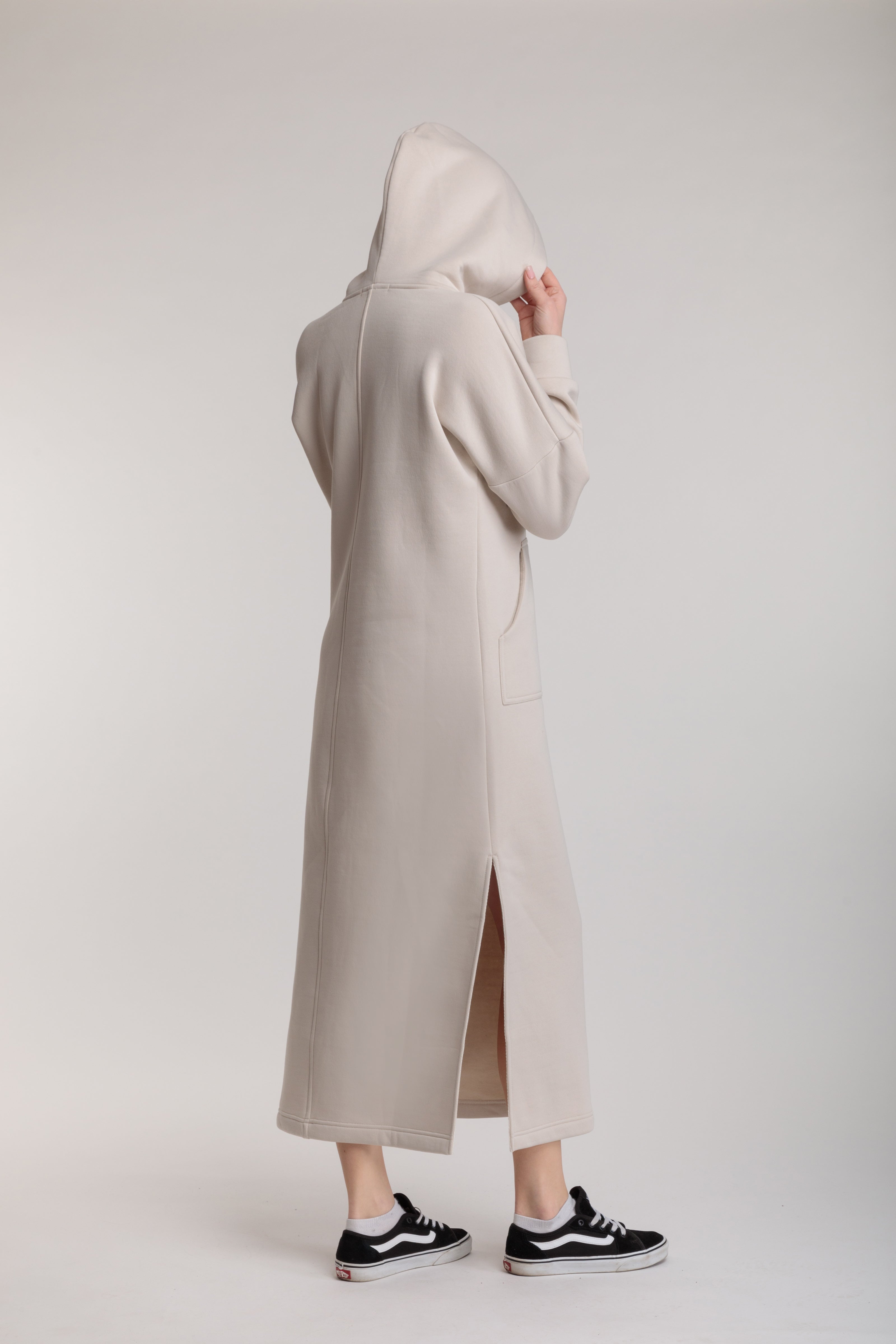 Long straight warm hooded dress in milk color with slits, and a kangaroo pocket