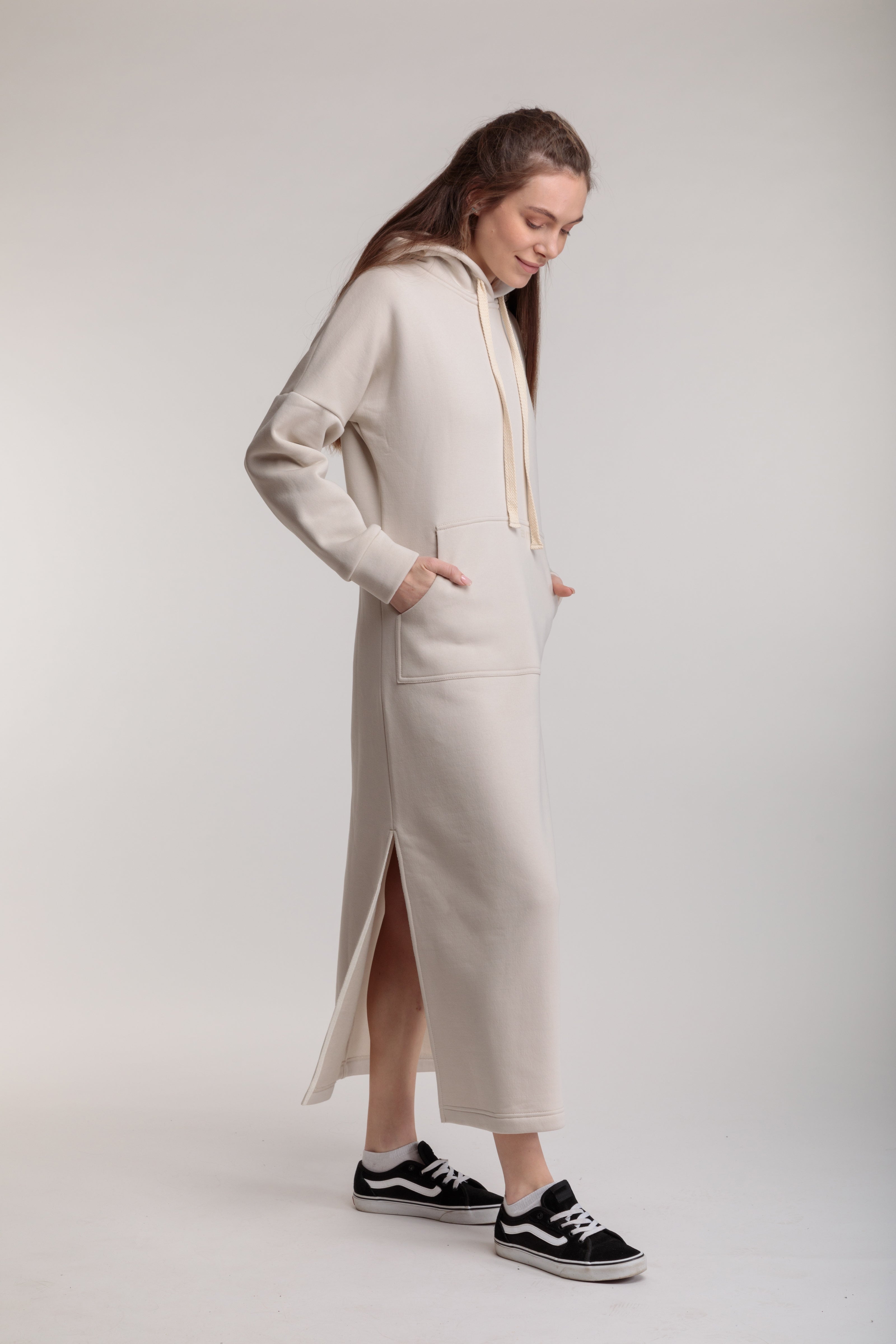 Long straight warm hooded dress in milk color with slits, and a kangaroo pocket