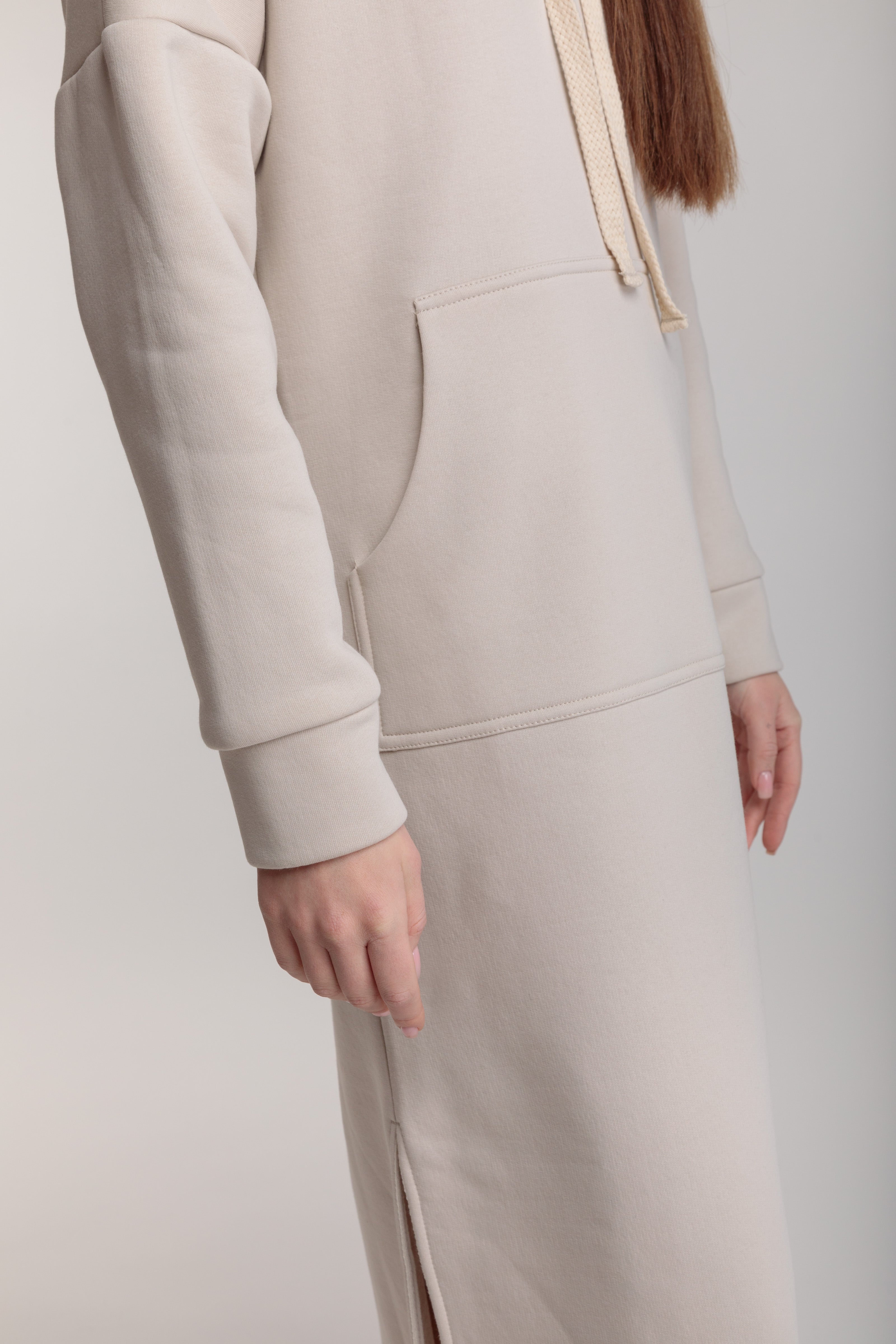 Long straight warm hooded dress in milk color with slits, and a kangaroo pocket