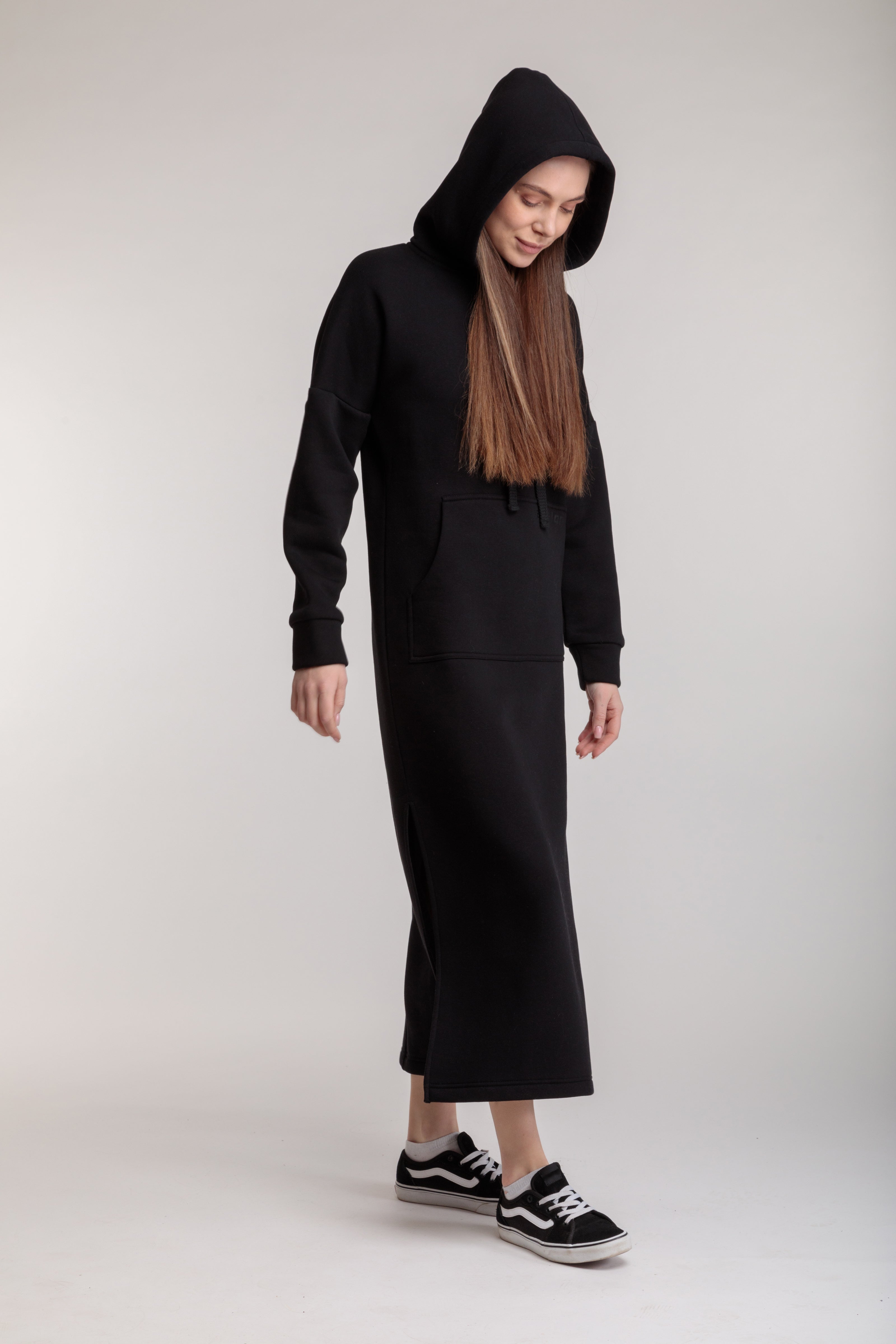 Long straight warm hooded dress in black color with slits, and a kangaroo pocket