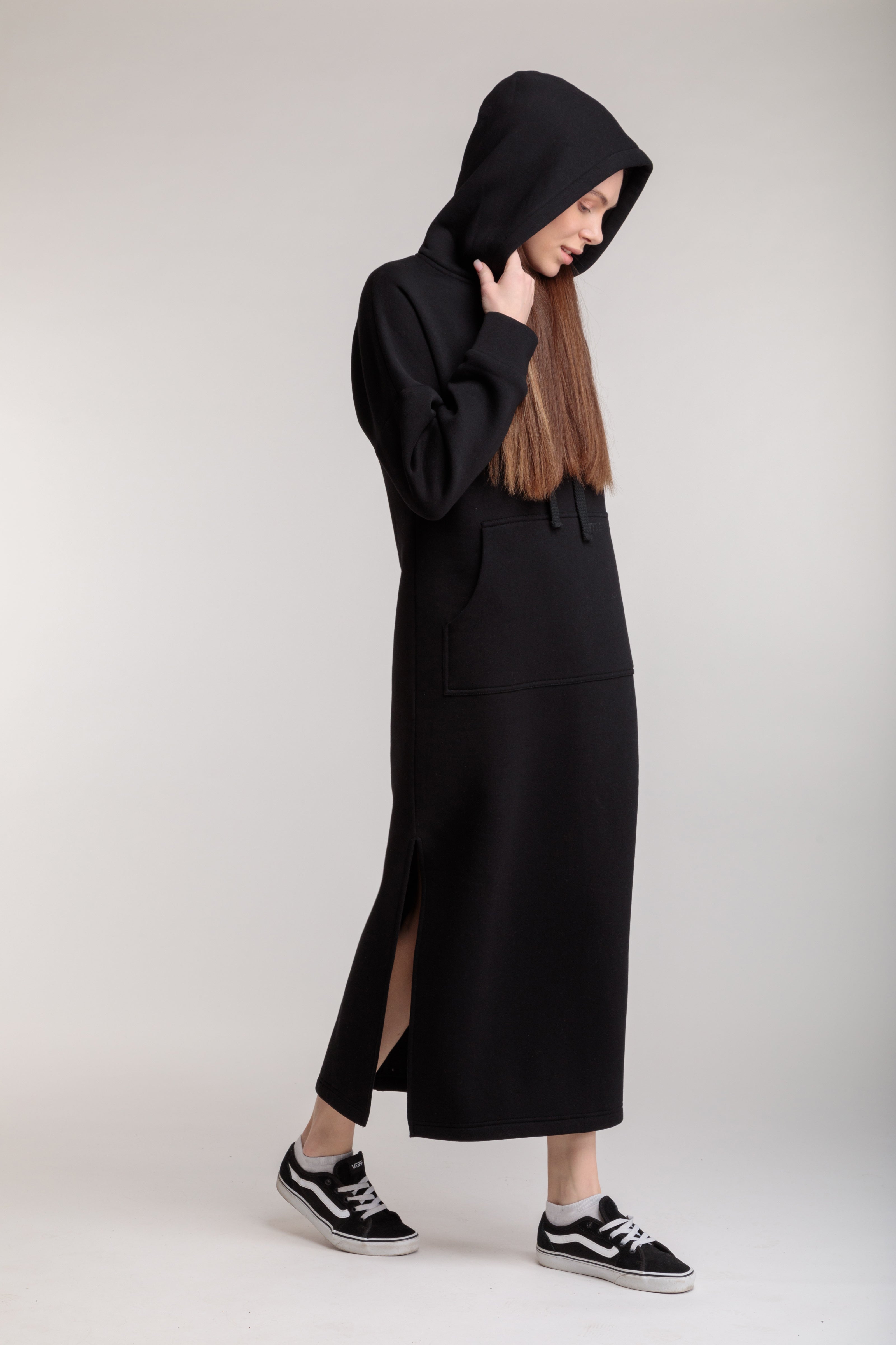 Long straight warm hooded dress in black color with slits, and a kangaroo pocket