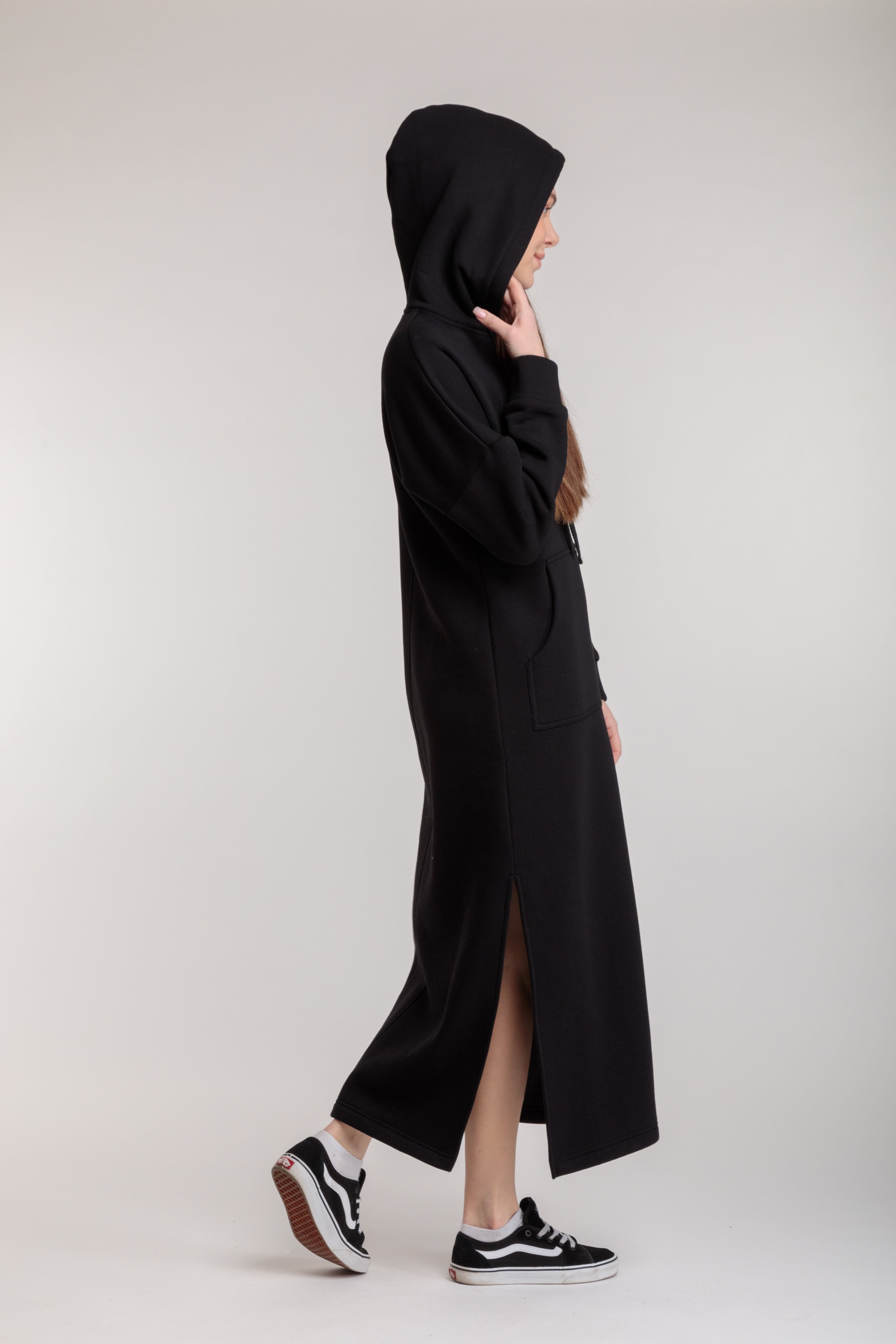 Long straight warm hooded dress in black color with slits, and a kangaroo pocket